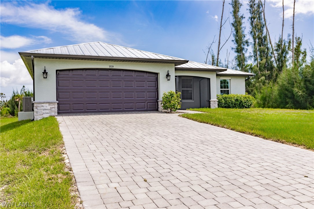 a front view of a house with a yard and garage