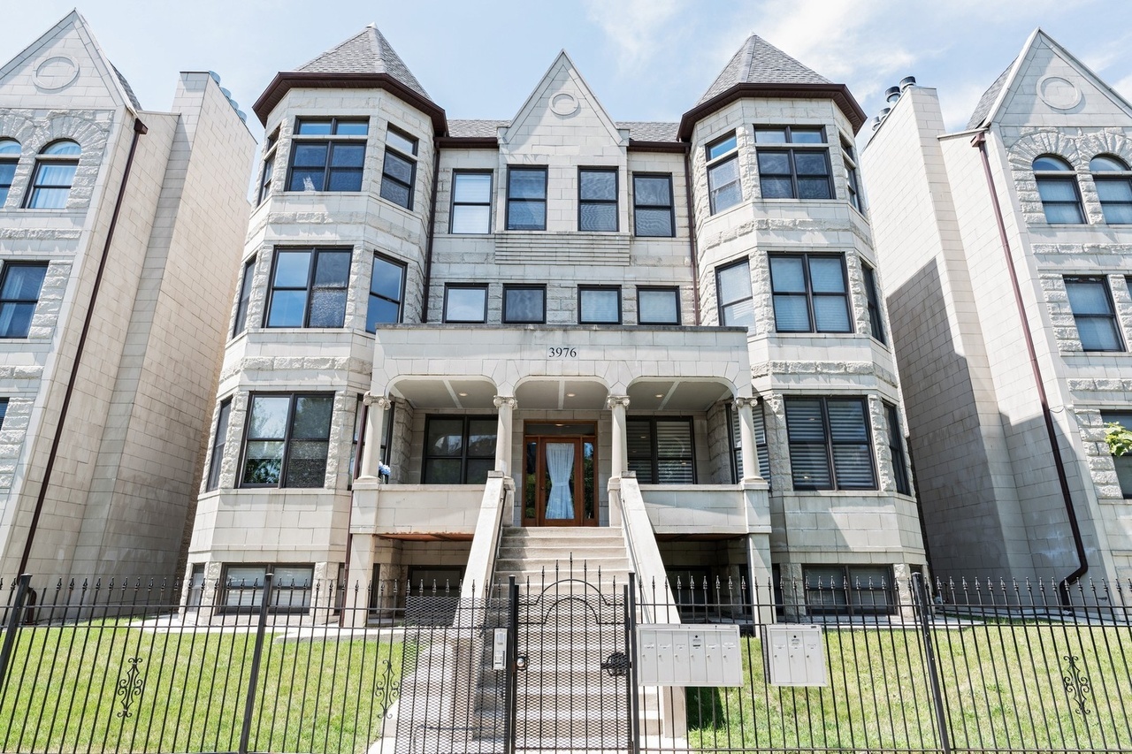 a front view of a residential apartment building with a yard