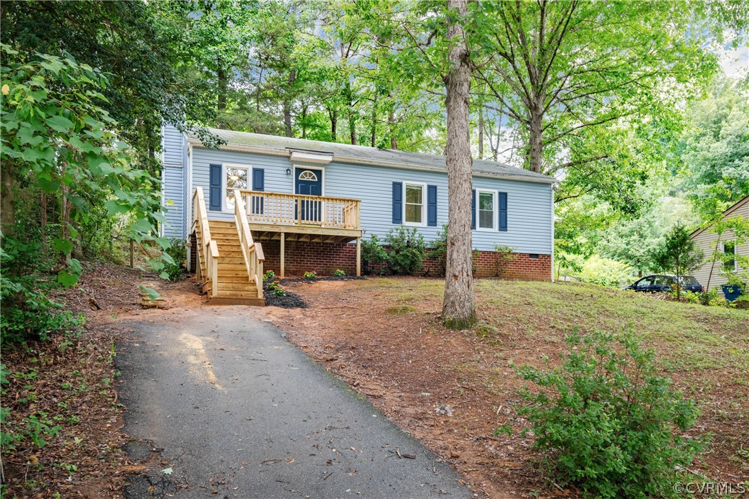 a view of house with outdoor space and trees