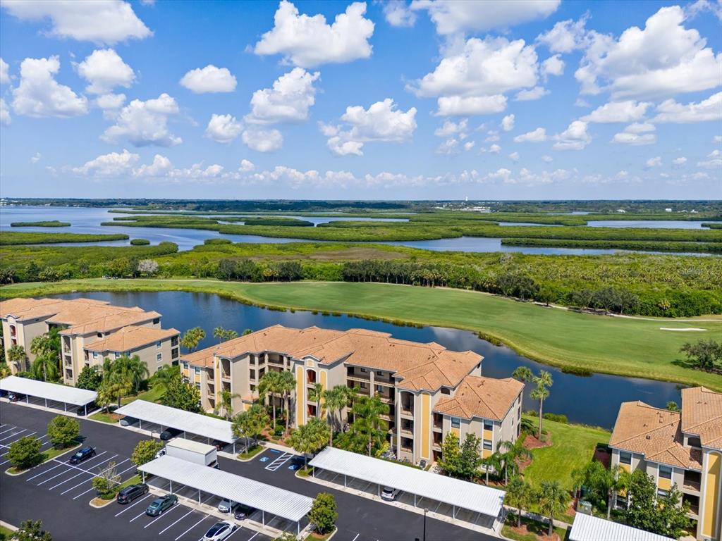 an aerial view of a house with a garden and lake view