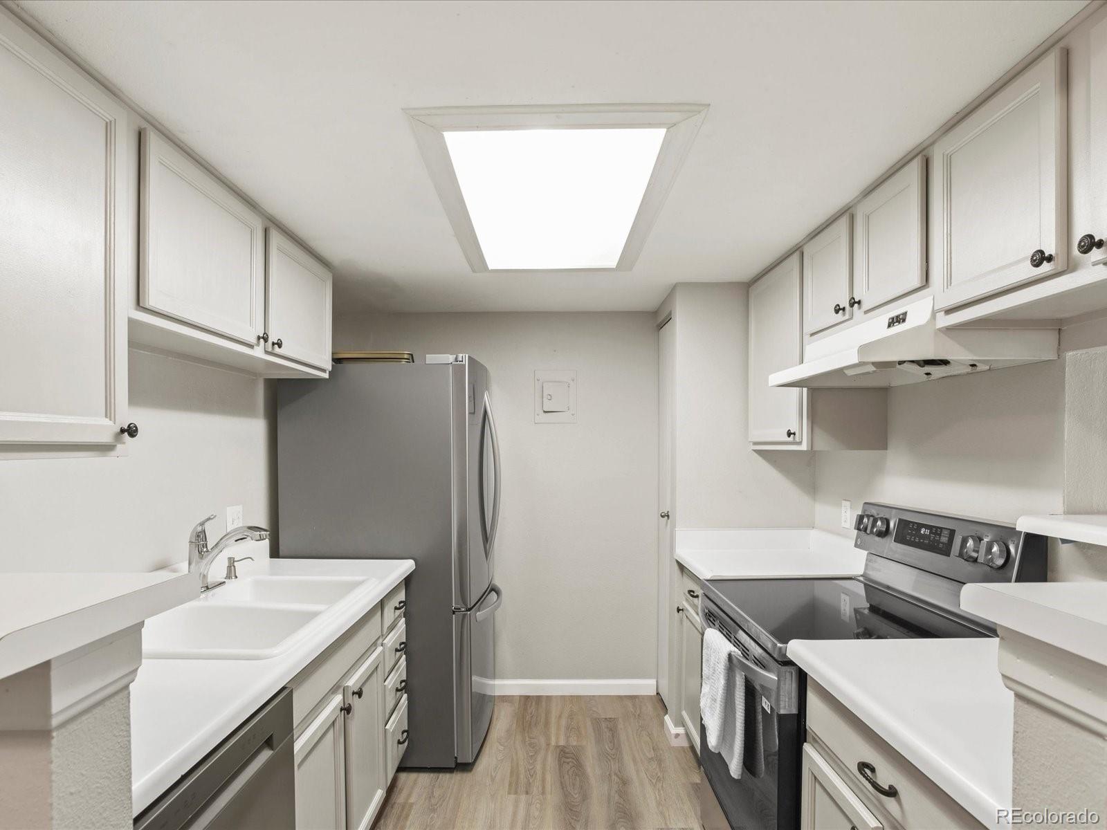 a kitchen with a sink cabinets and stainless steel appliances