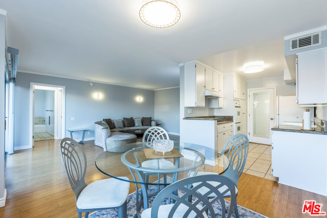 a dining room with furniture a table and kitchen view