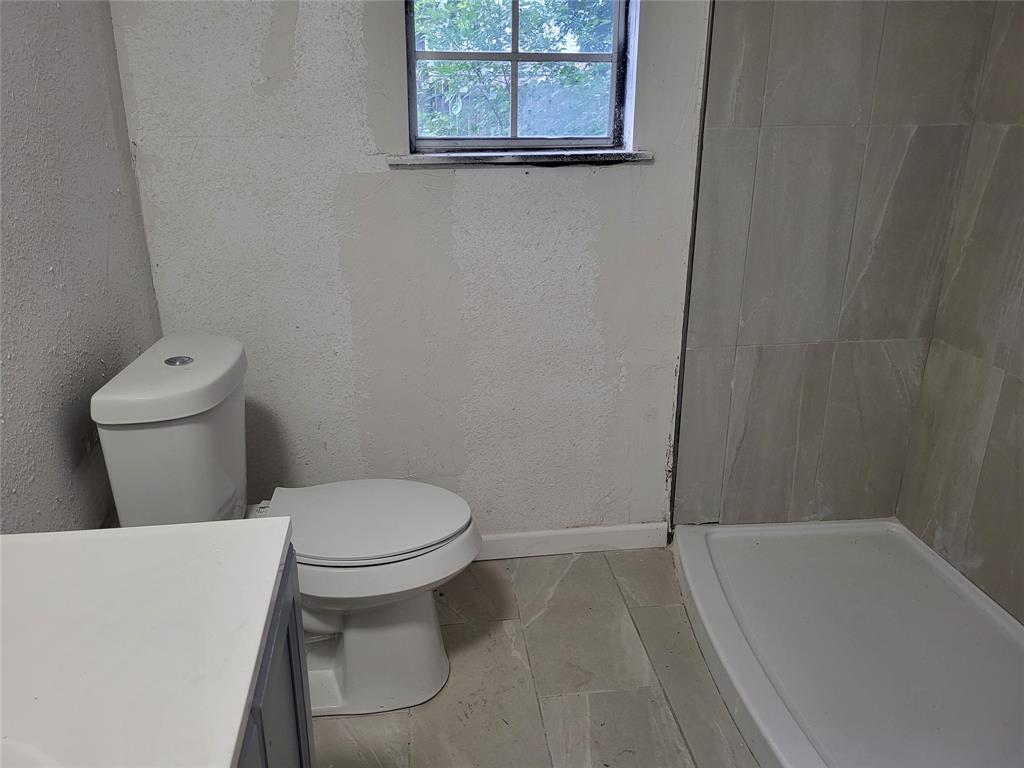 a bathroom with a toilet and a tub