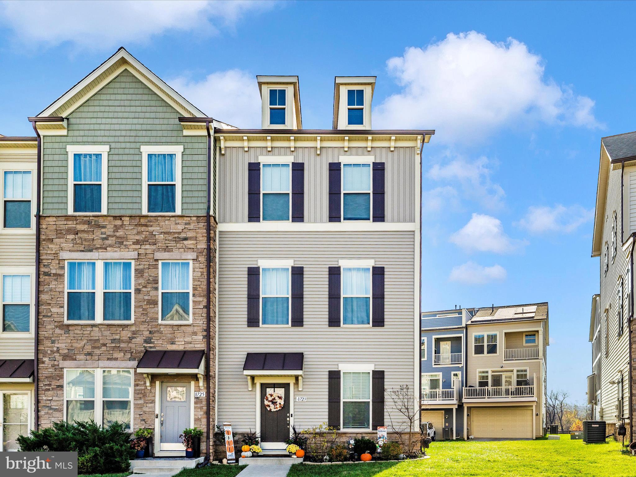 a front view of a residential apartment building with a yard