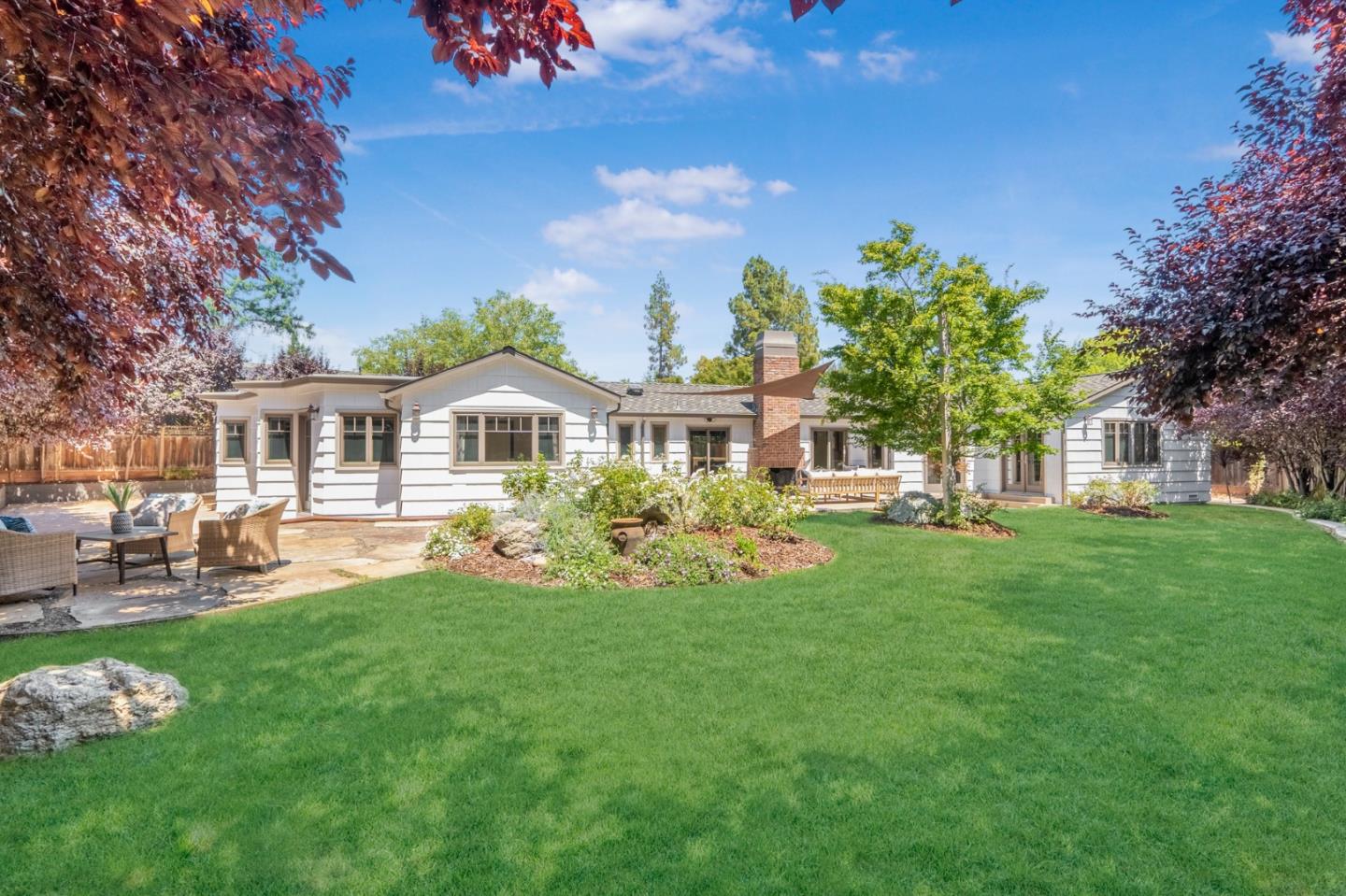 a front view of a house with garden and porch