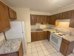 a kitchen with a refrigerator sink and stove