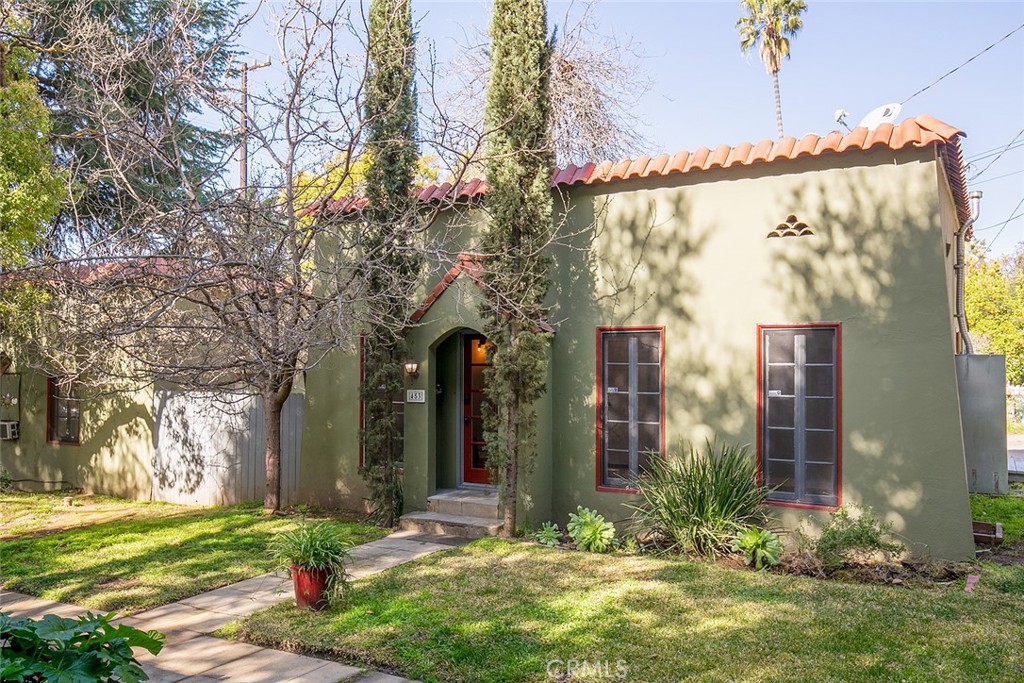 a view of a house with a yard and tree s