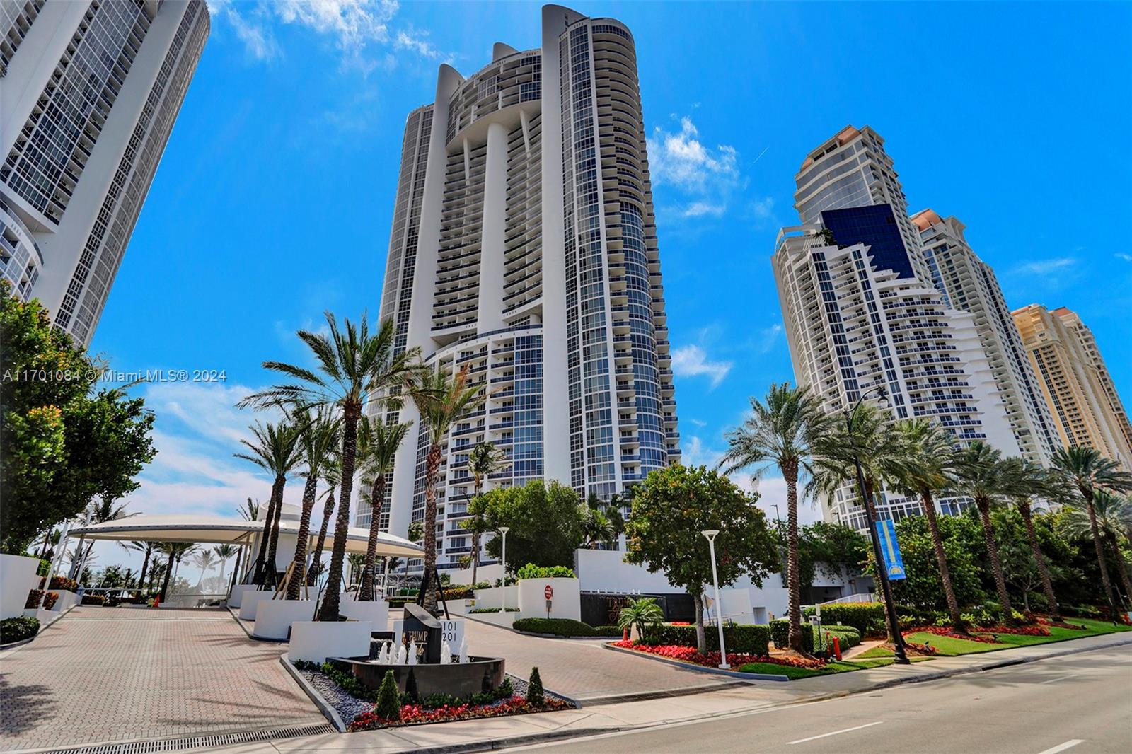 a view of a tall building next to a road