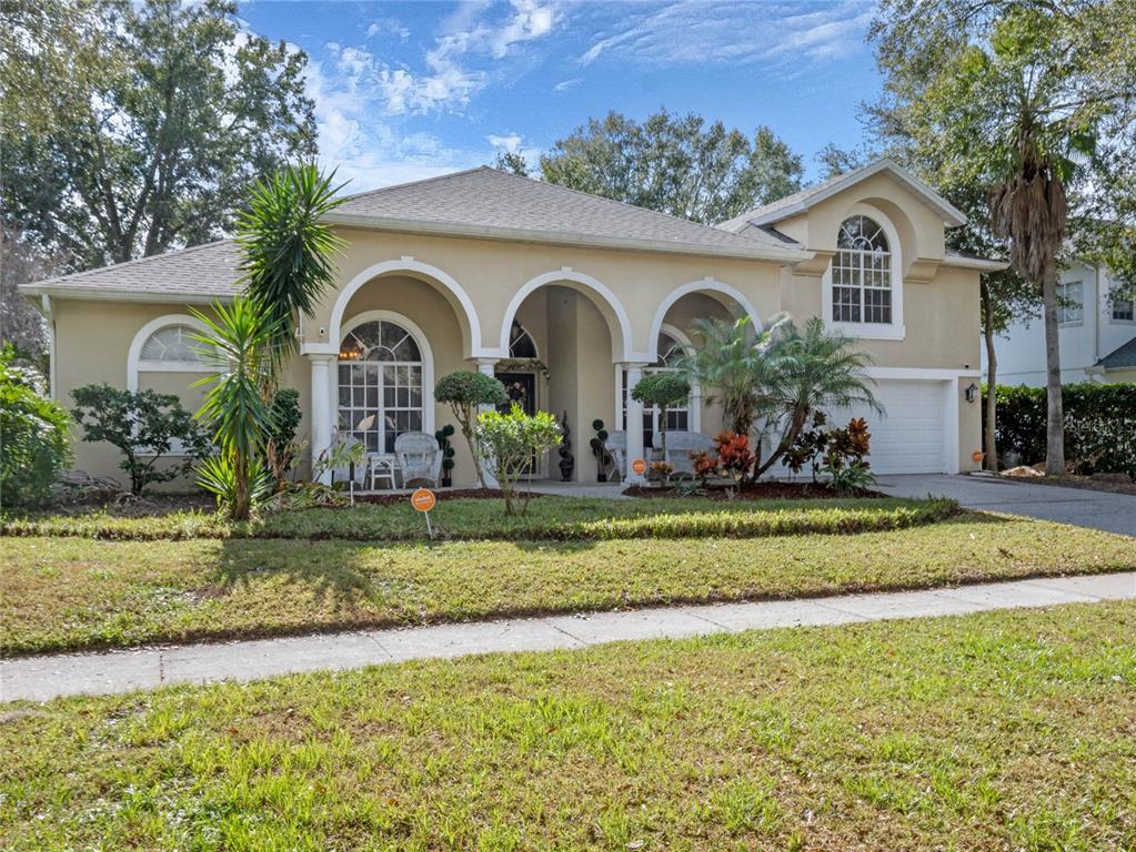 a front view of a house with a garden