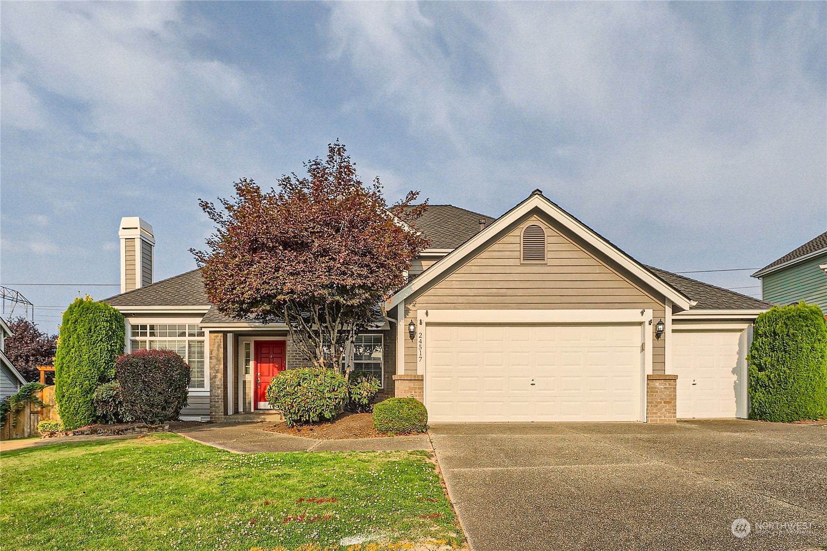 a front view of a house with a yard and garage