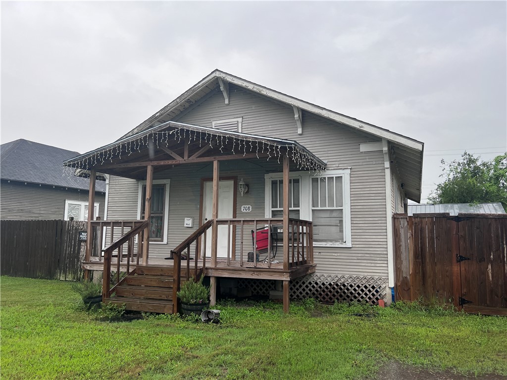 a front view of a house with a yard table and chairs