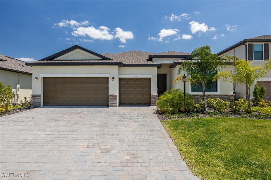 a front view of a house with a yard and garage