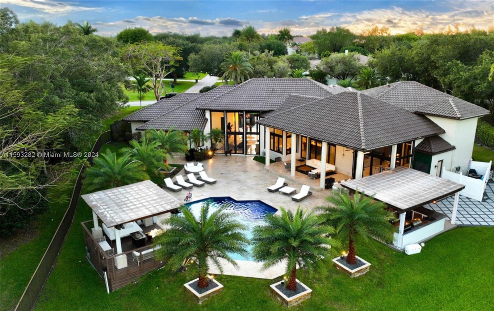 an aerial view of a house with swimming pool and patio