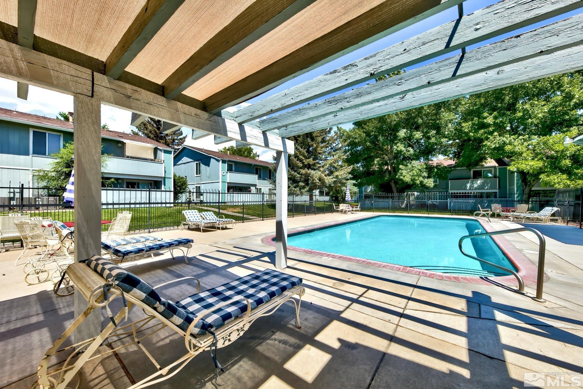 a view of a patio with a table and chairs