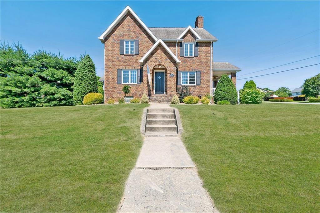 a front view of a house with a yard