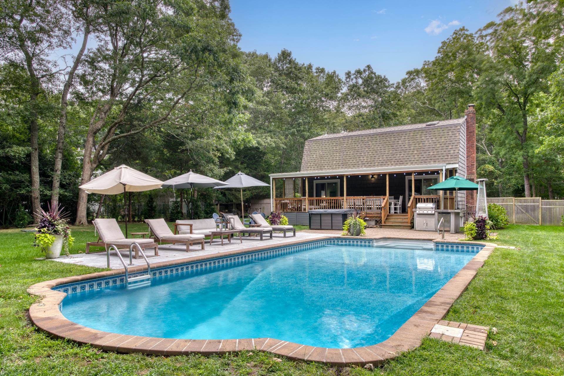 a view of a house with swimming pool and sitting area