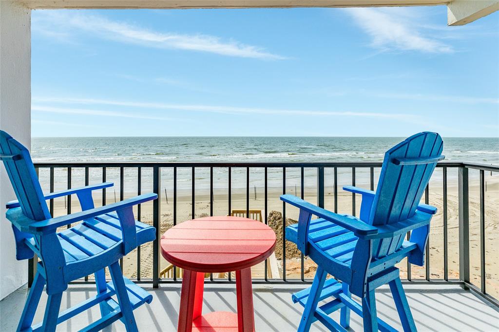 a view of a balcony with a table and chairs