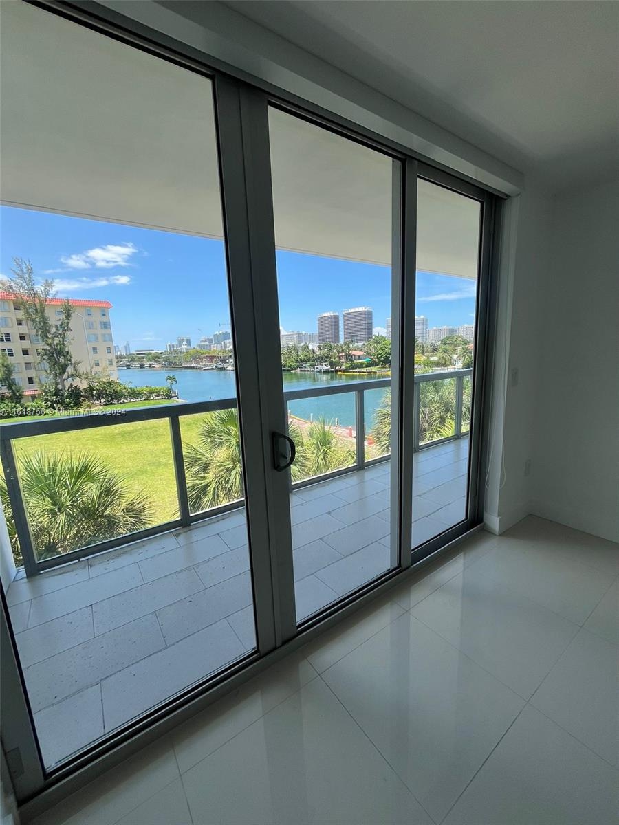 a view of a floor to ceiling window and an ocean view