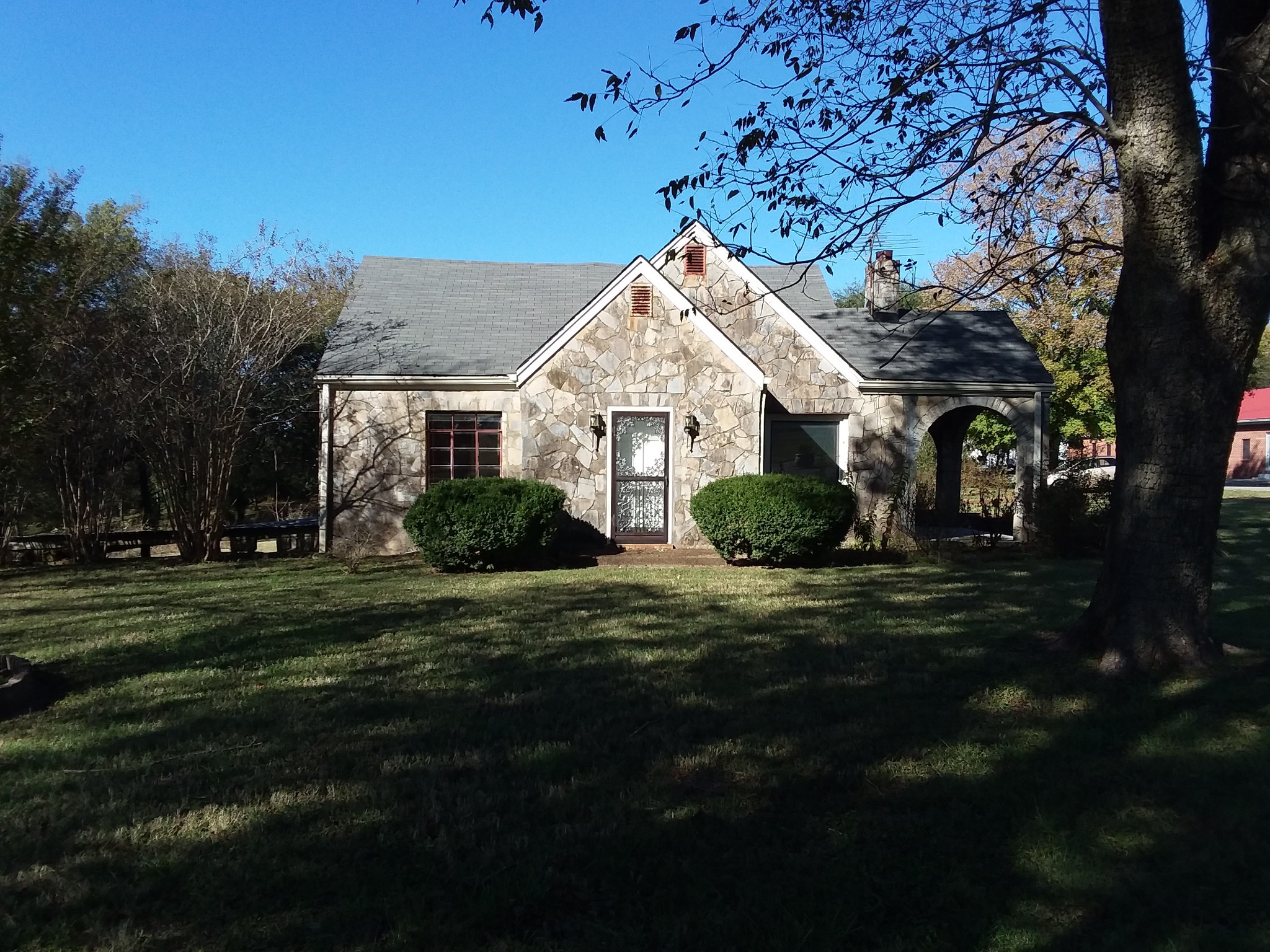 a front view of a house with a garden