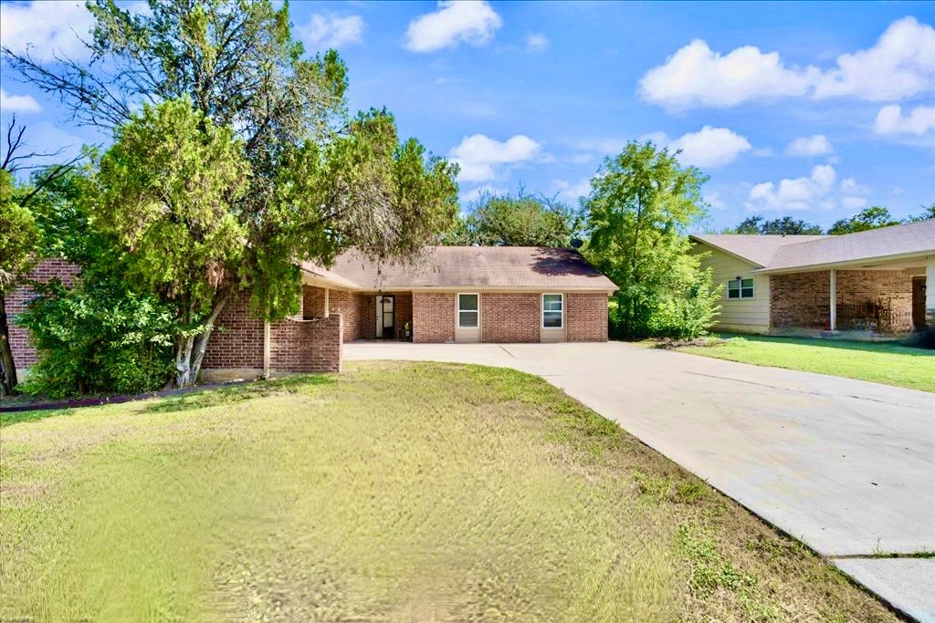 a front view of house with yard and green space