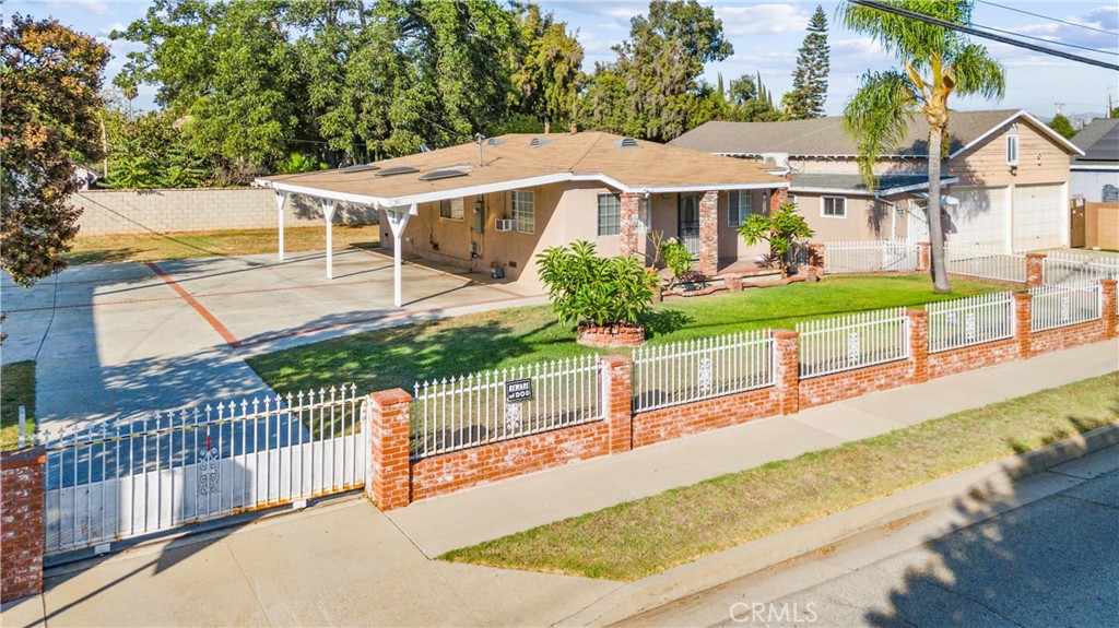 a view of a house with wooden fence