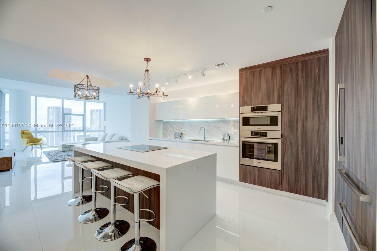 a kitchen with kitchen island granite countertop a sink stove and cabinets