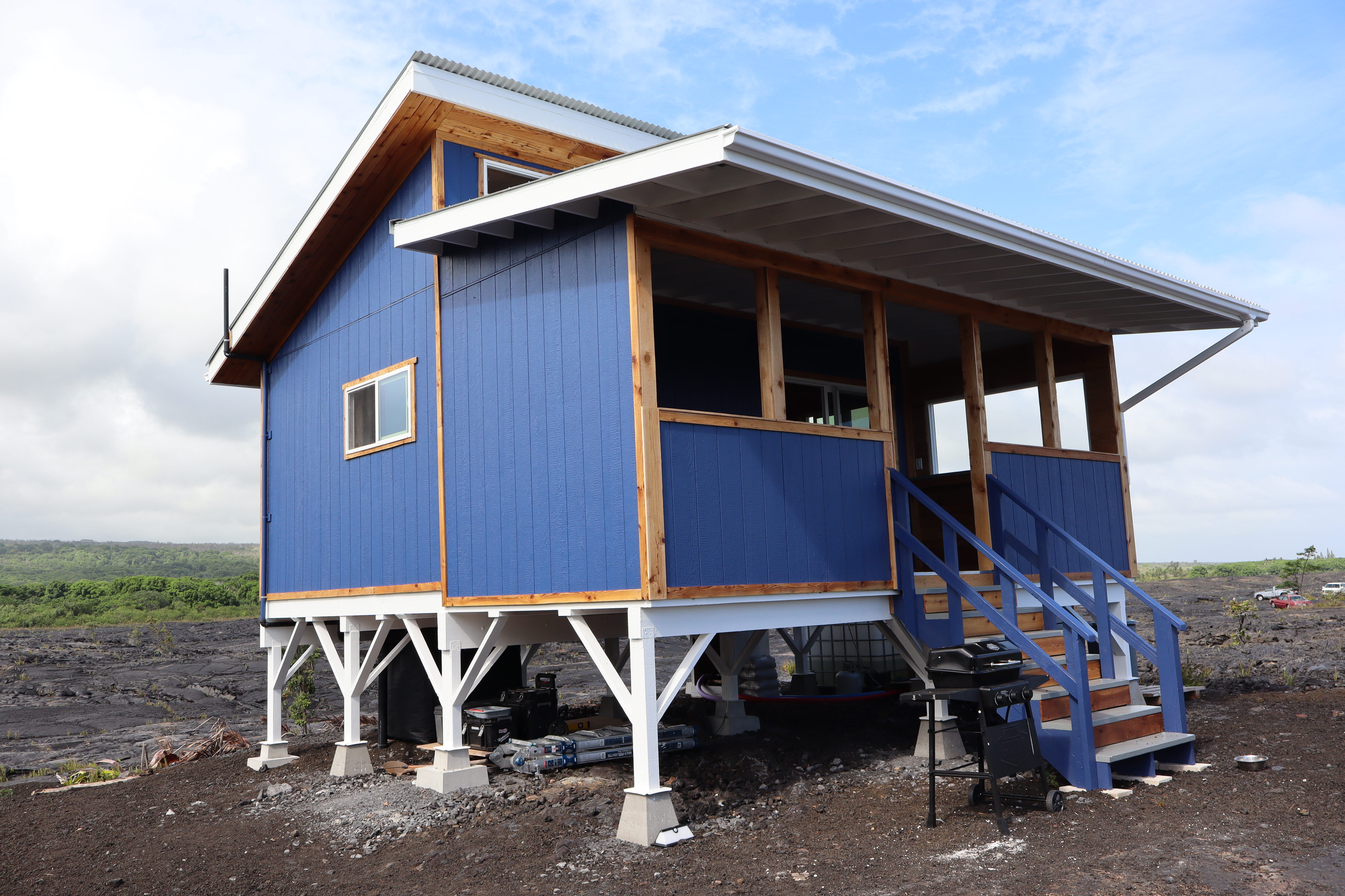 a front view of a house with wooden stairs