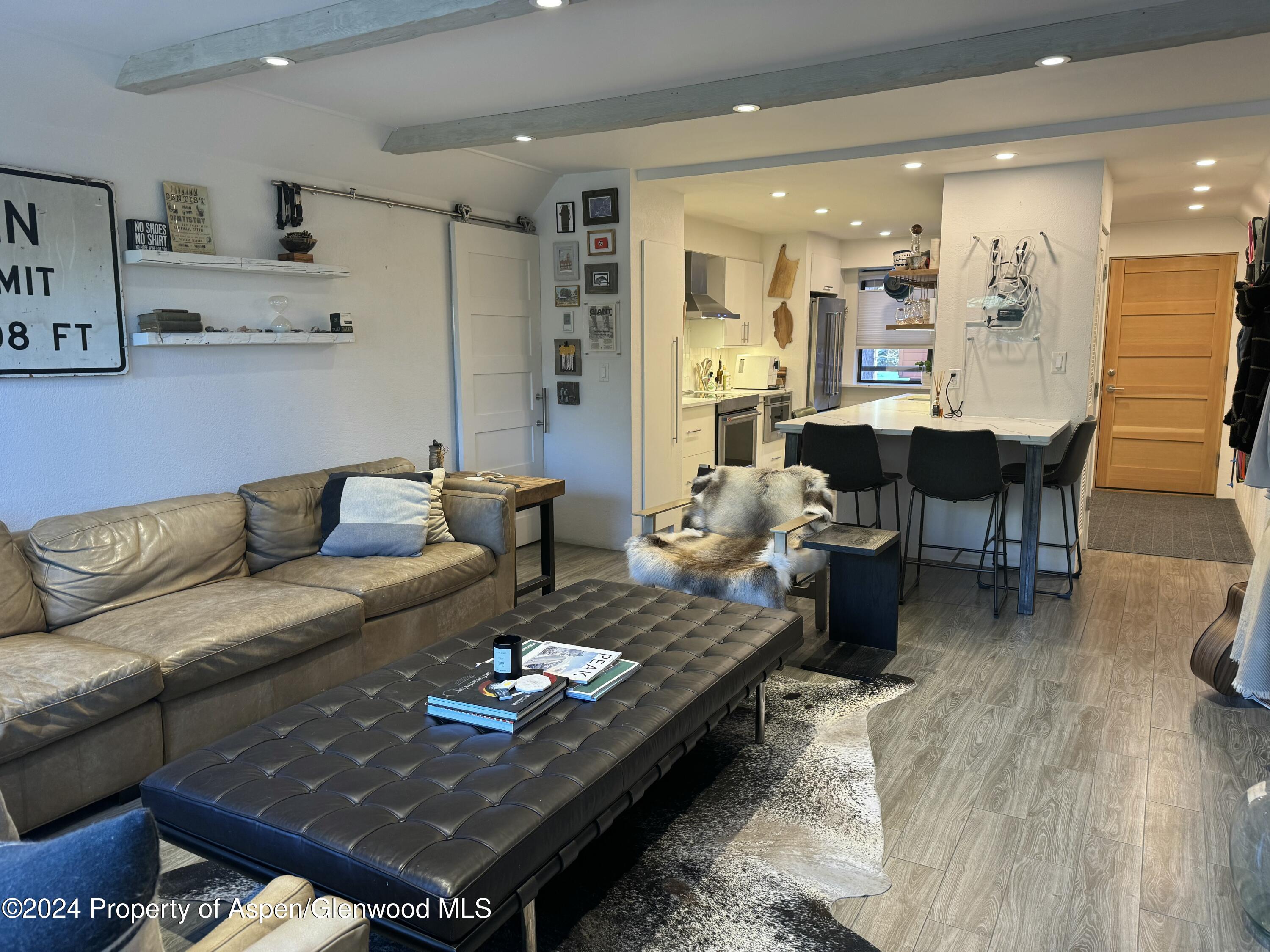 a living room with furniture and a dining table