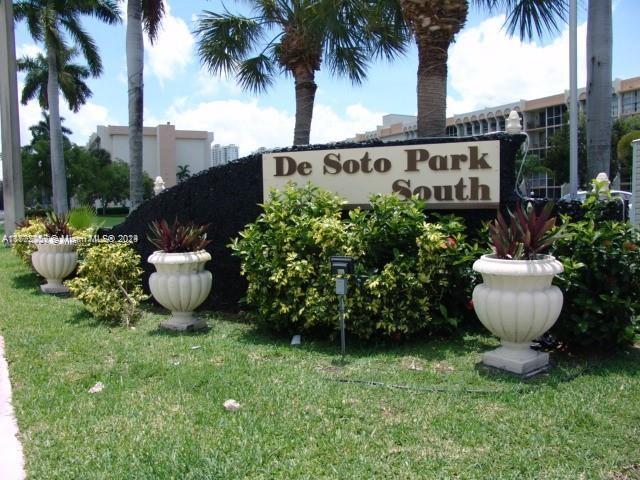 a view of a backyard with potted plants and palm trees