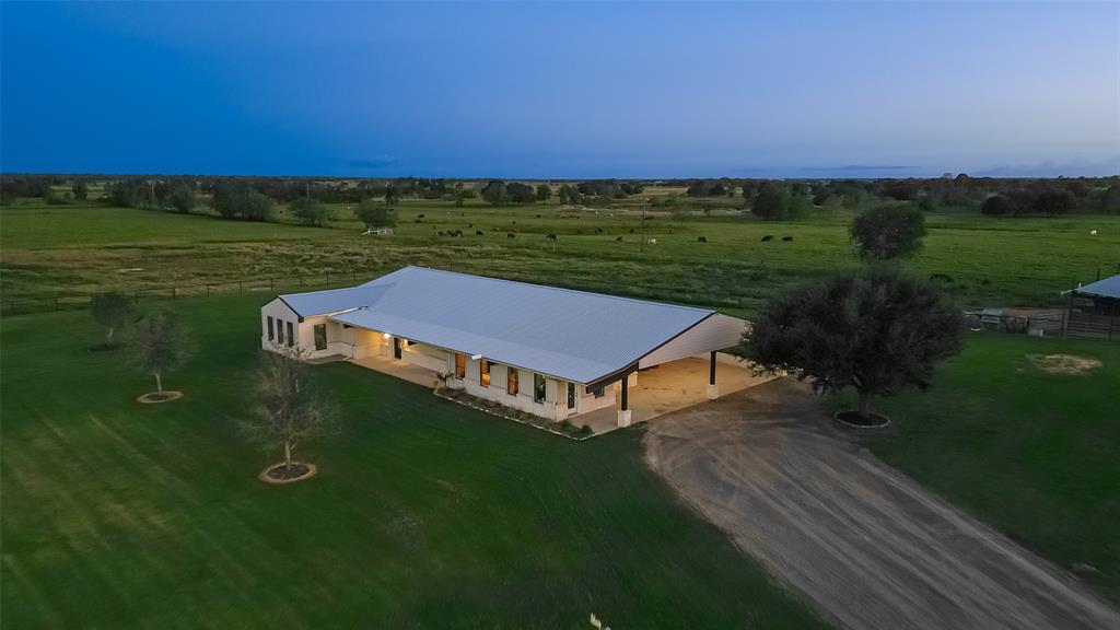 a view of a big yard with an ocean view