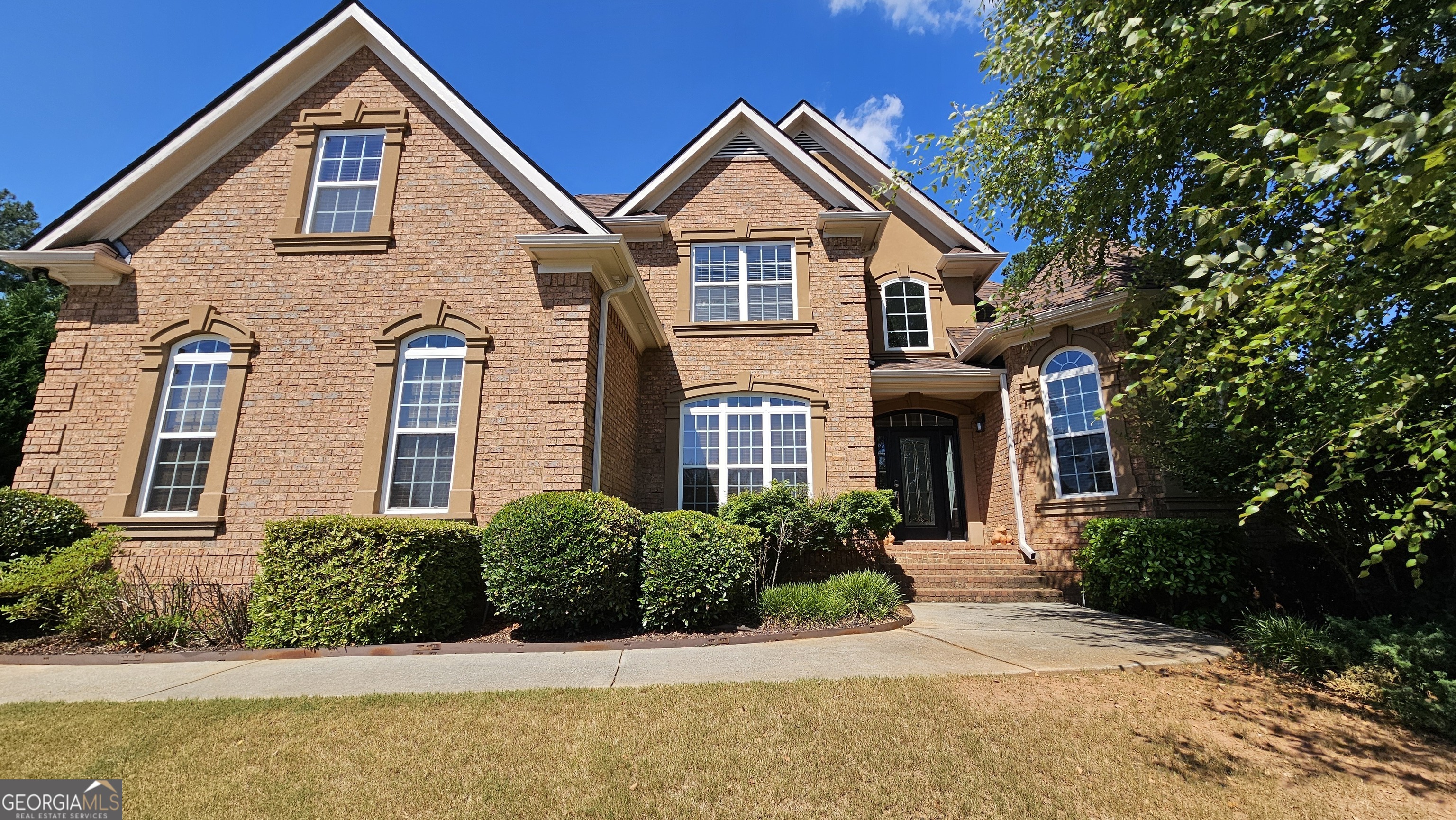 a front view of a house with a yard and garage