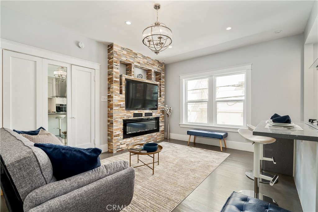 a living room with furniture a flat screen tv and a window