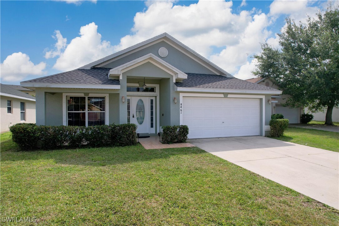 a front view of a house with a yard and garage