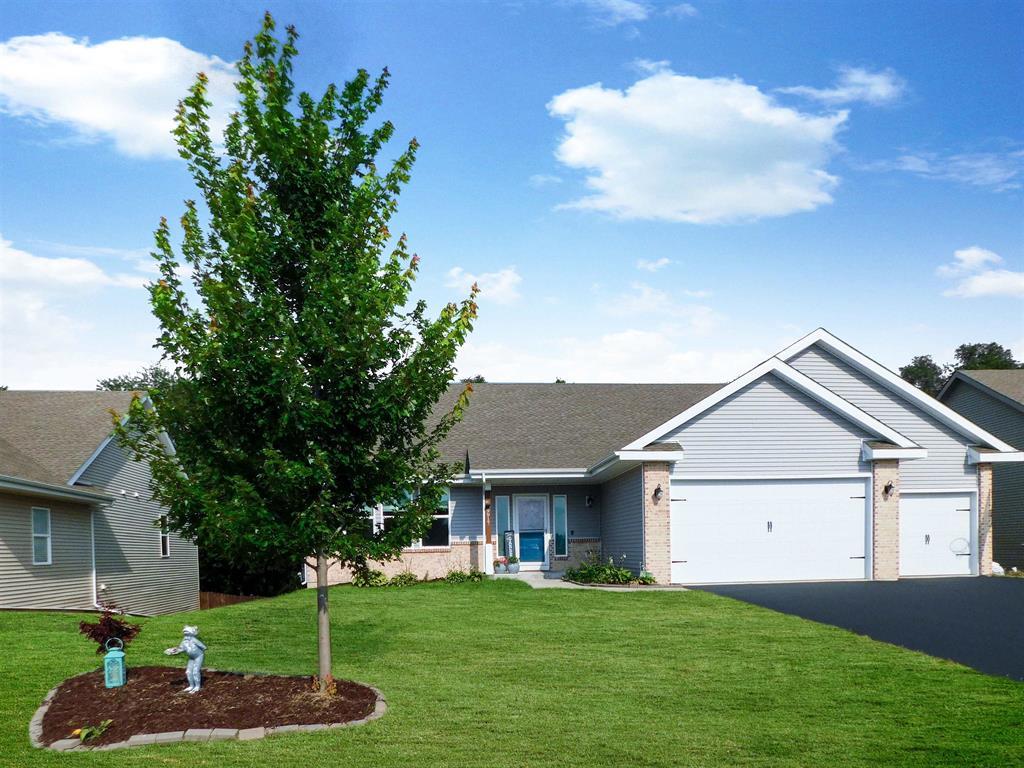 a front view of house with yard and green space