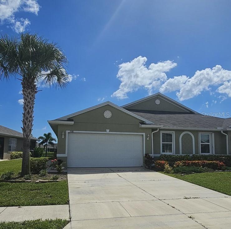 a front view of a house with a yard and garage