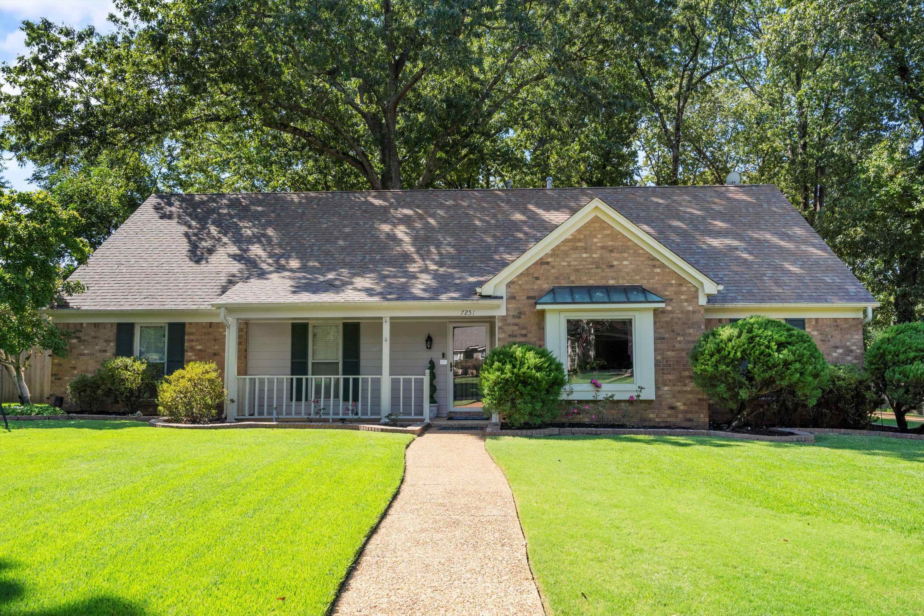 a front view of house with yard and green space