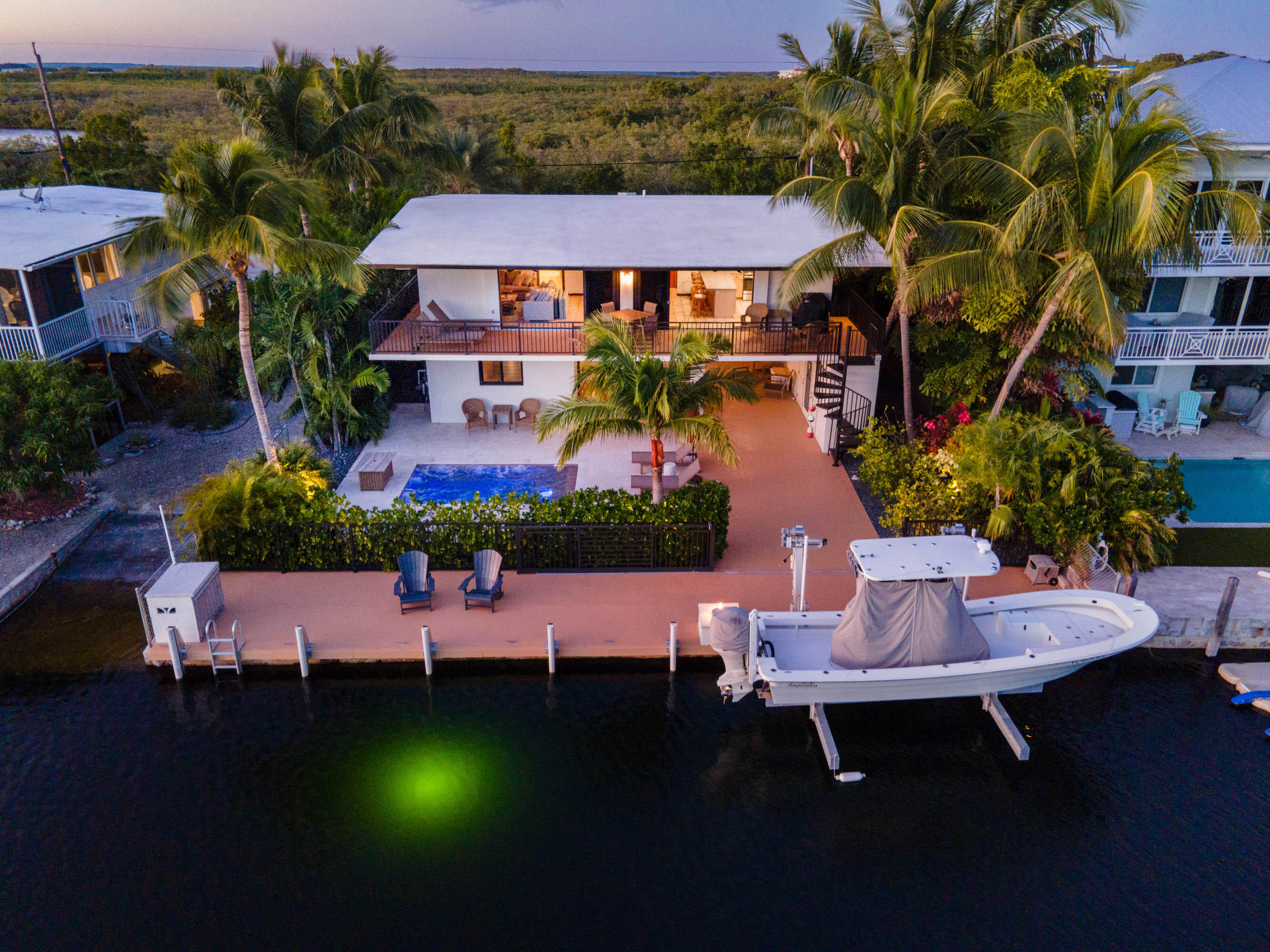 a aerial view of a house with swimming pool patio and outdoor seating