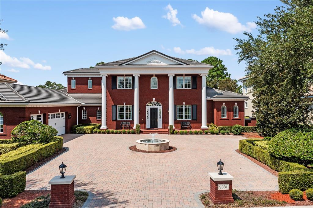 a front view of a house with yard and green space