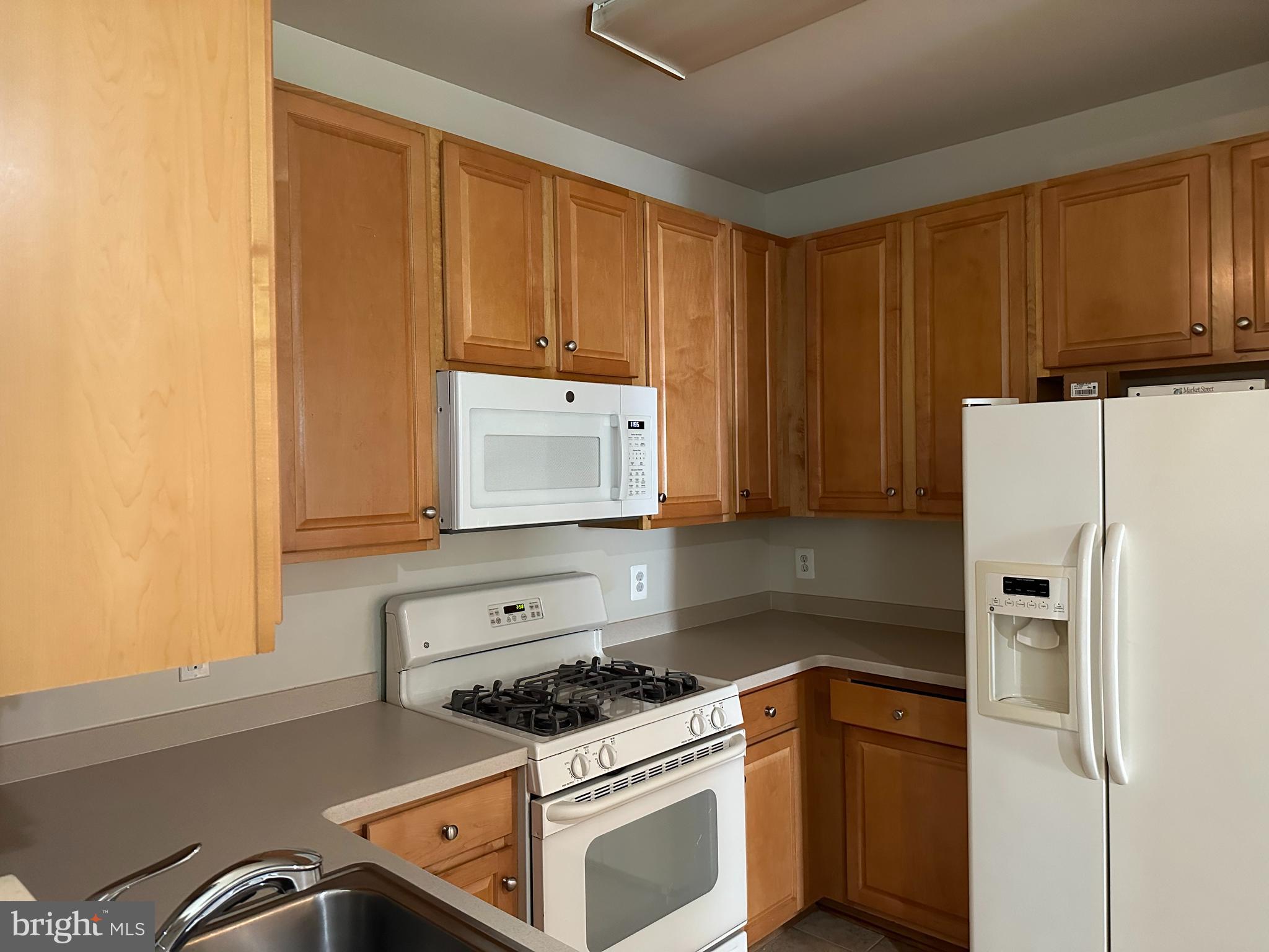 a kitchen with a stove and a refrigerator