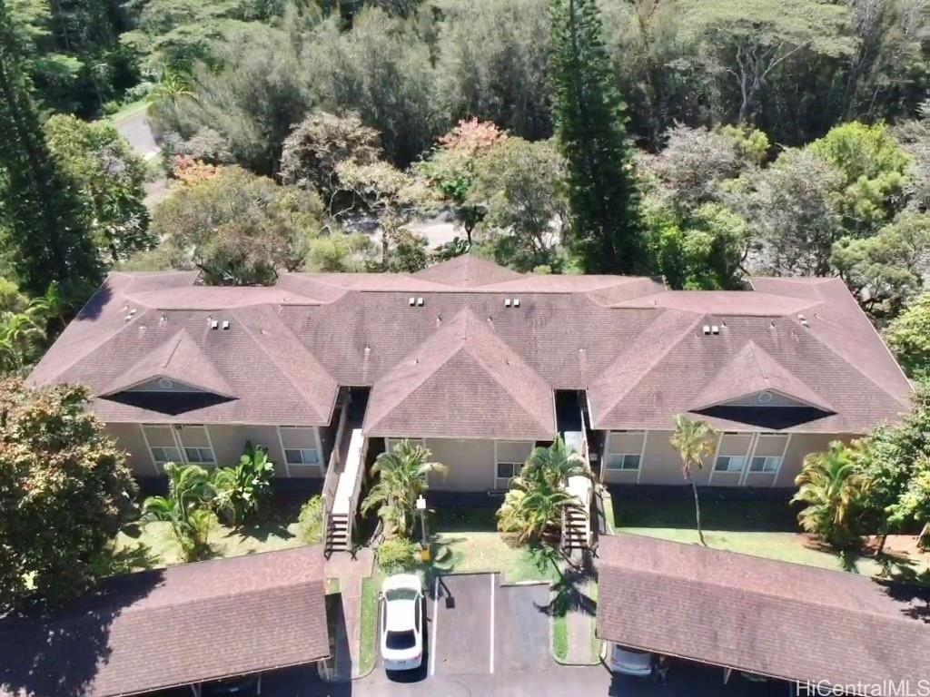 an aerial view of a house with garden space and a patio