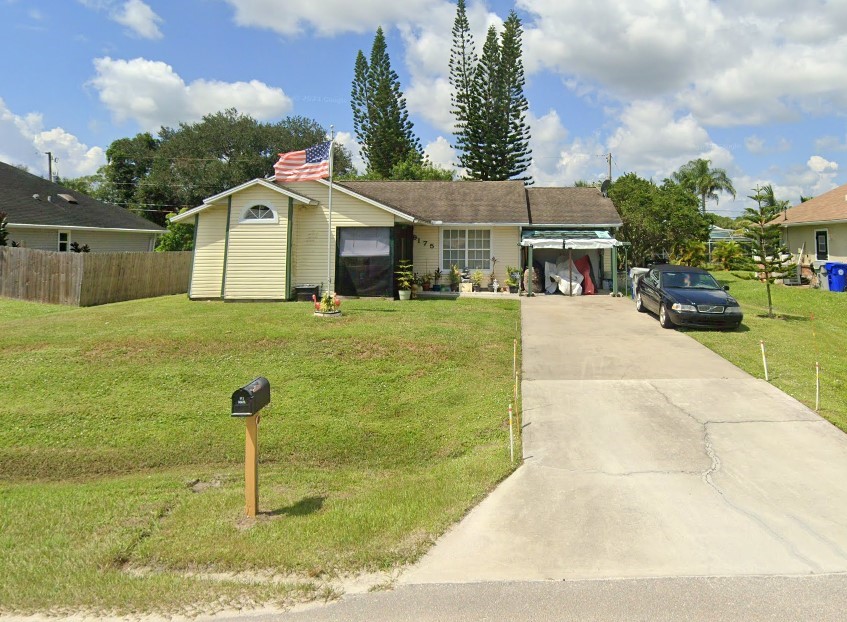 a front view of a house with a yard garage and outdoor seating