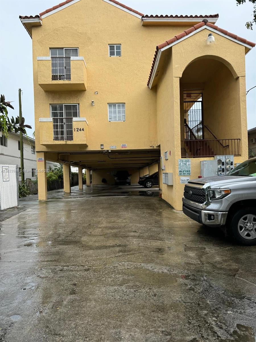 a view of a car park in front of a house