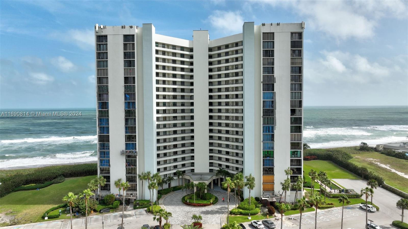 a front view of a building with a ocean view