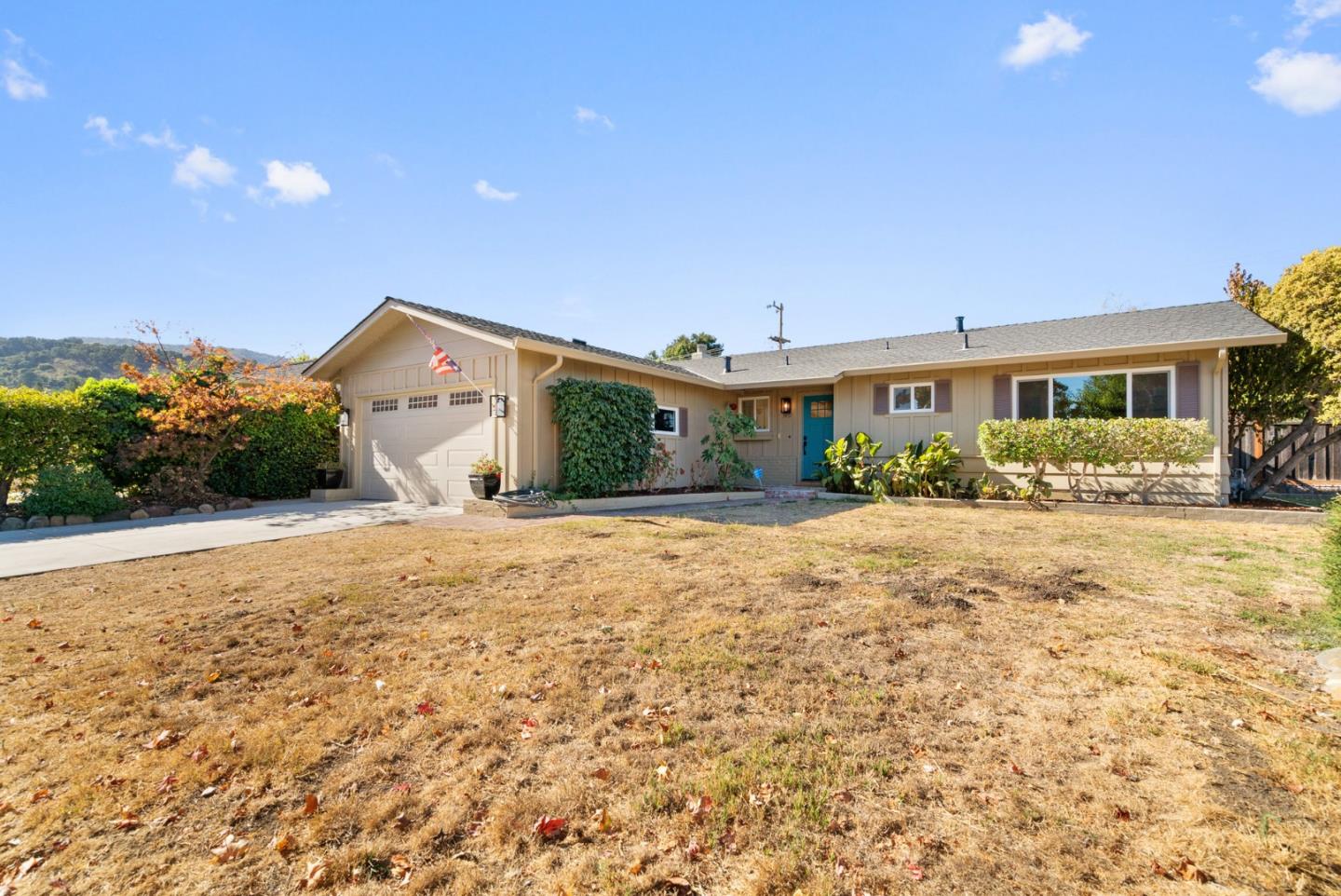 a front view of a house with a yard and outdoor seating