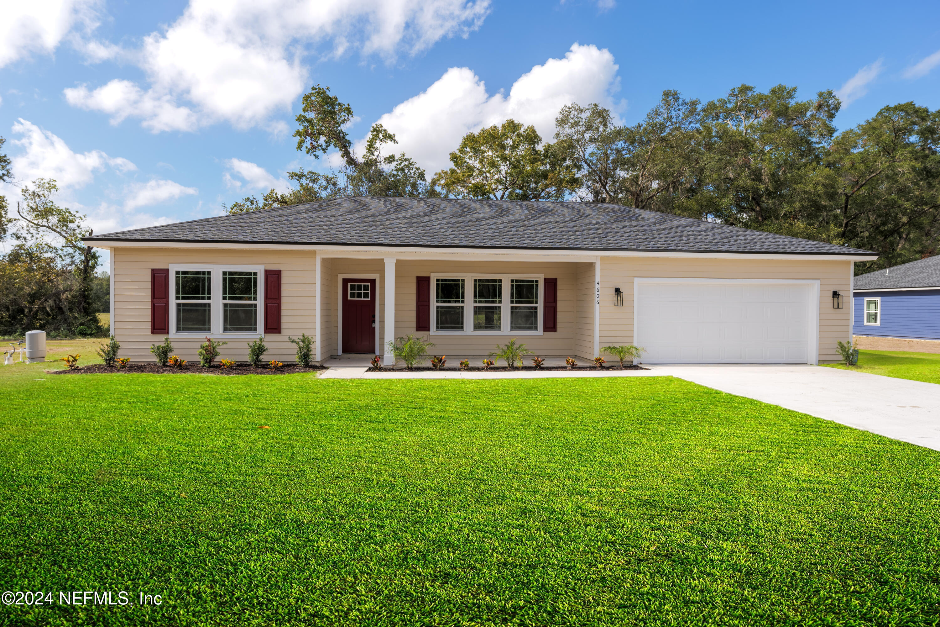 a front view of house with yard and green space