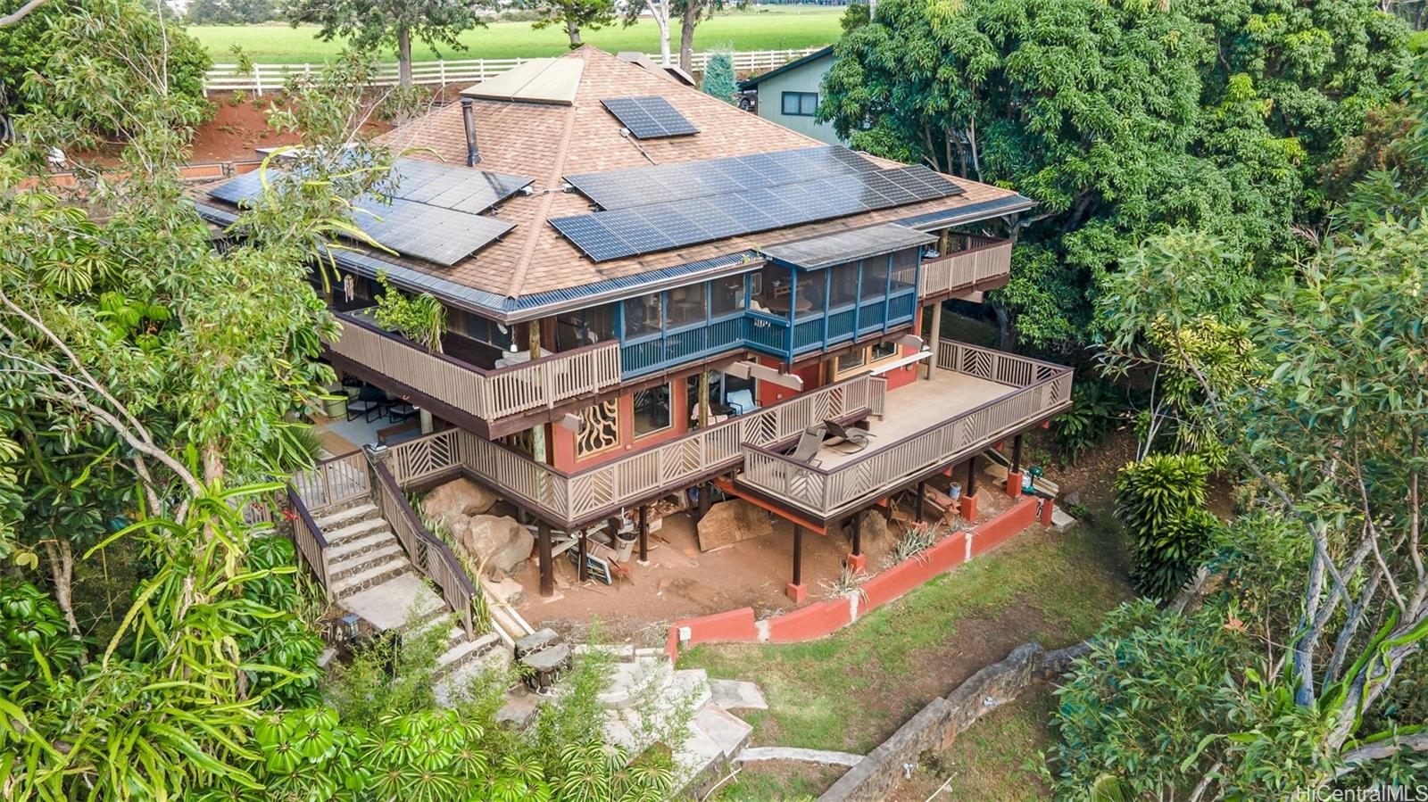 an aerial view of a house with a big yard