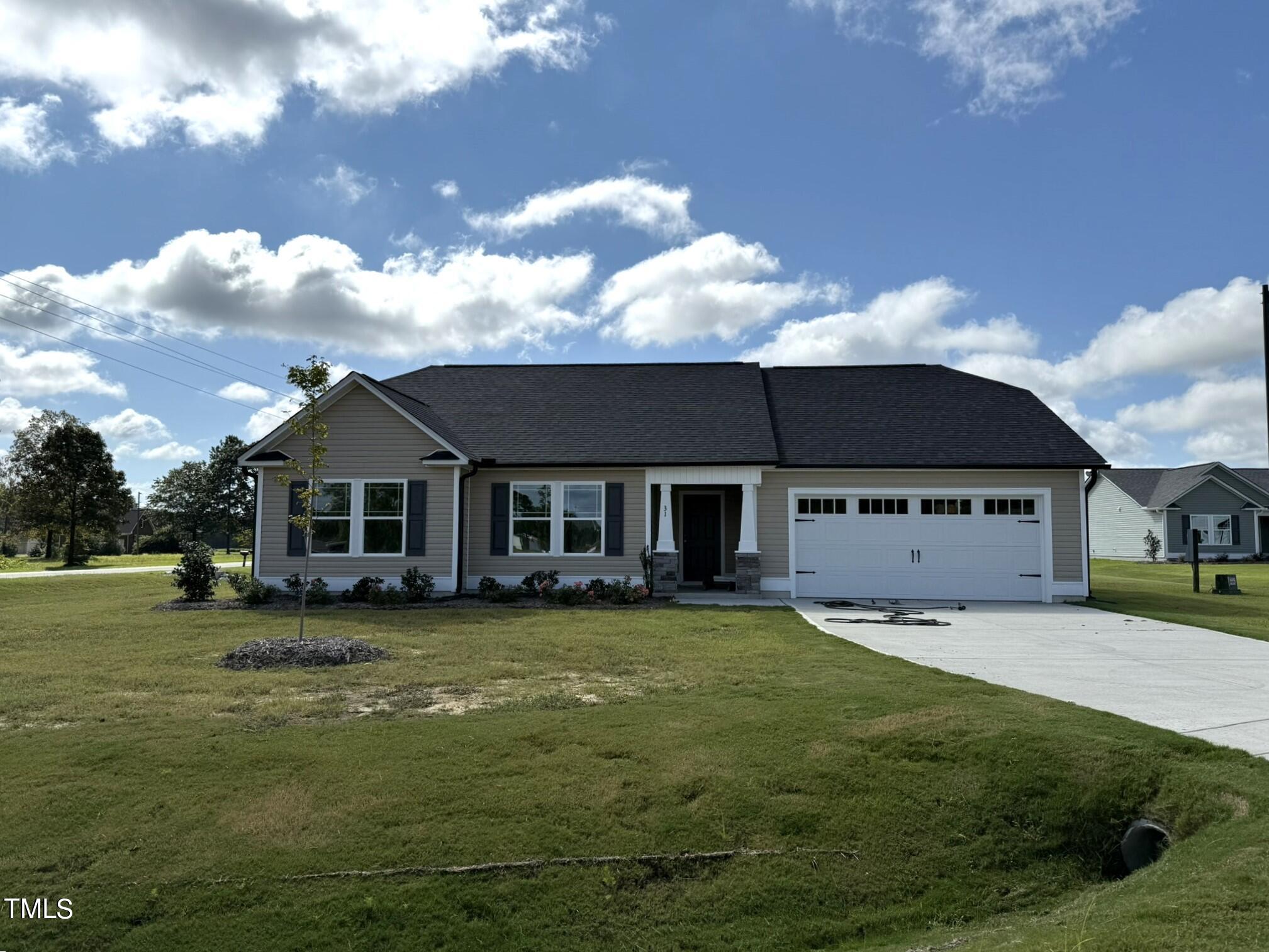 a view of a house with a yard and sitting area