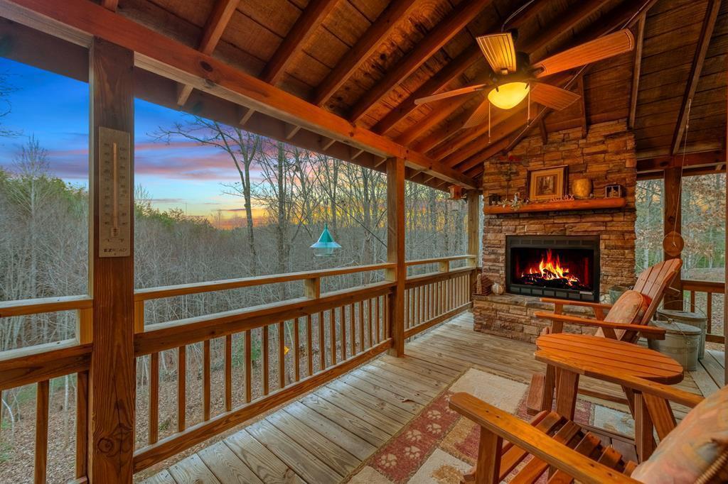 a view of a porch with furniture and a fireplace