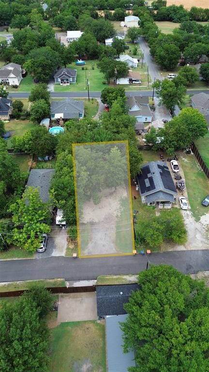 an aerial view of residential houses with outdoor space and parking