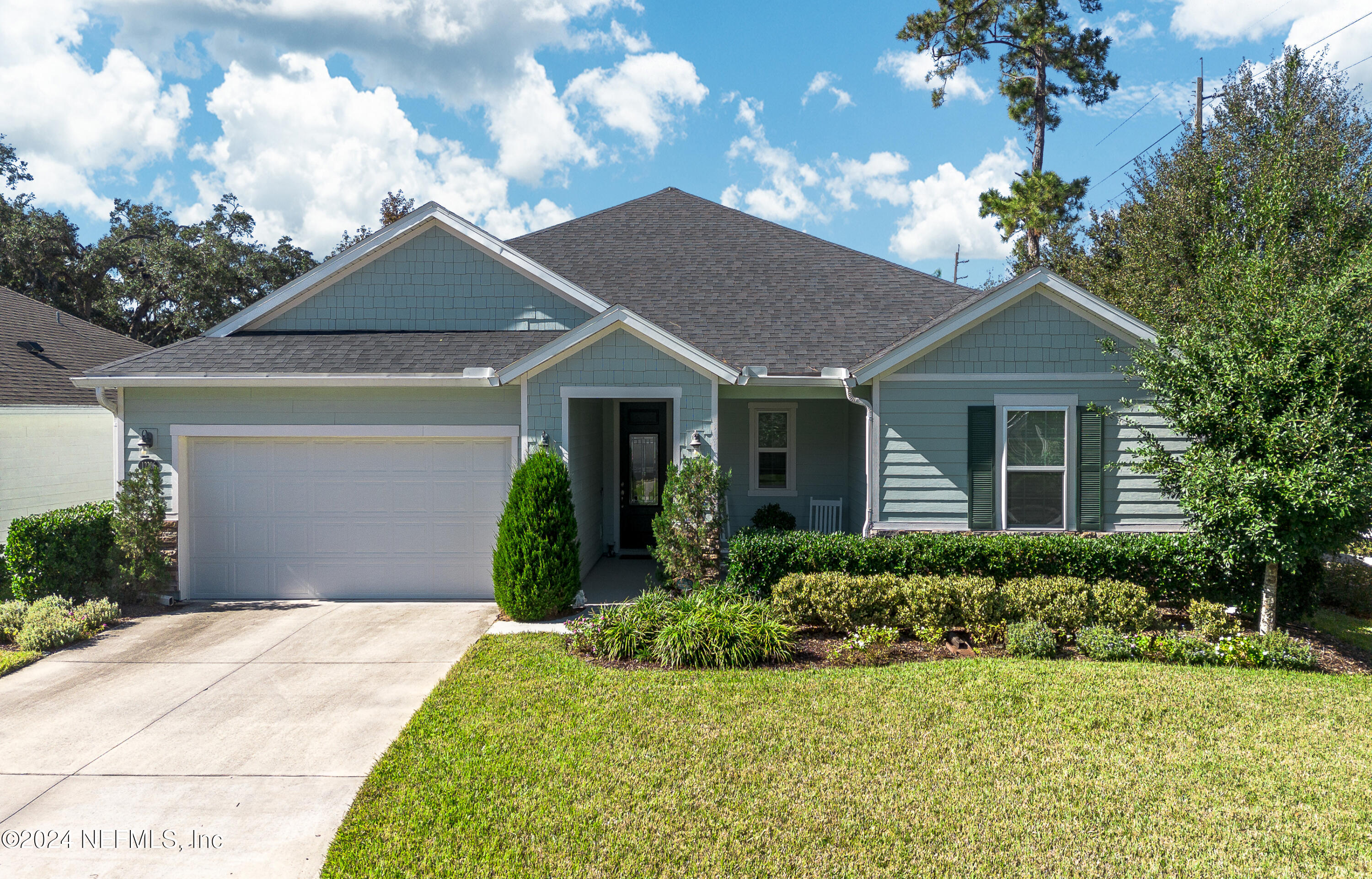 a front view of a house with a garden